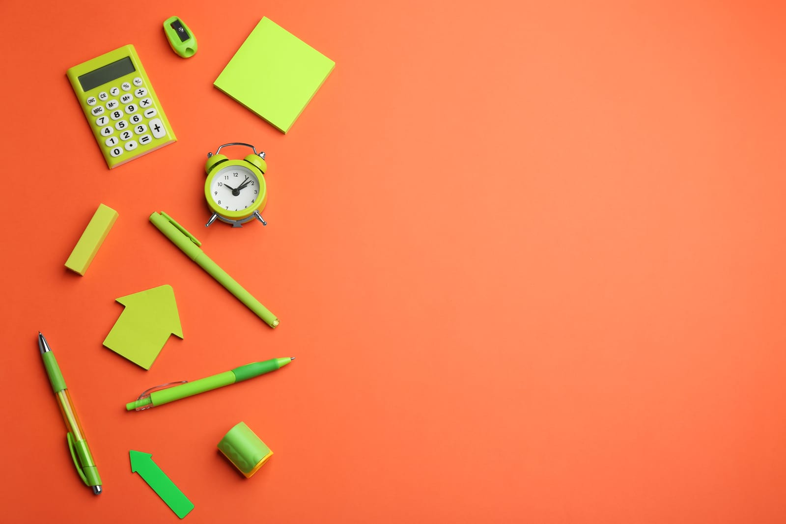 Bright stationery arranged on a coral background